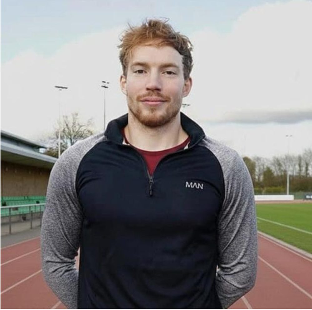 Lee Dollard standing on the track in training kit